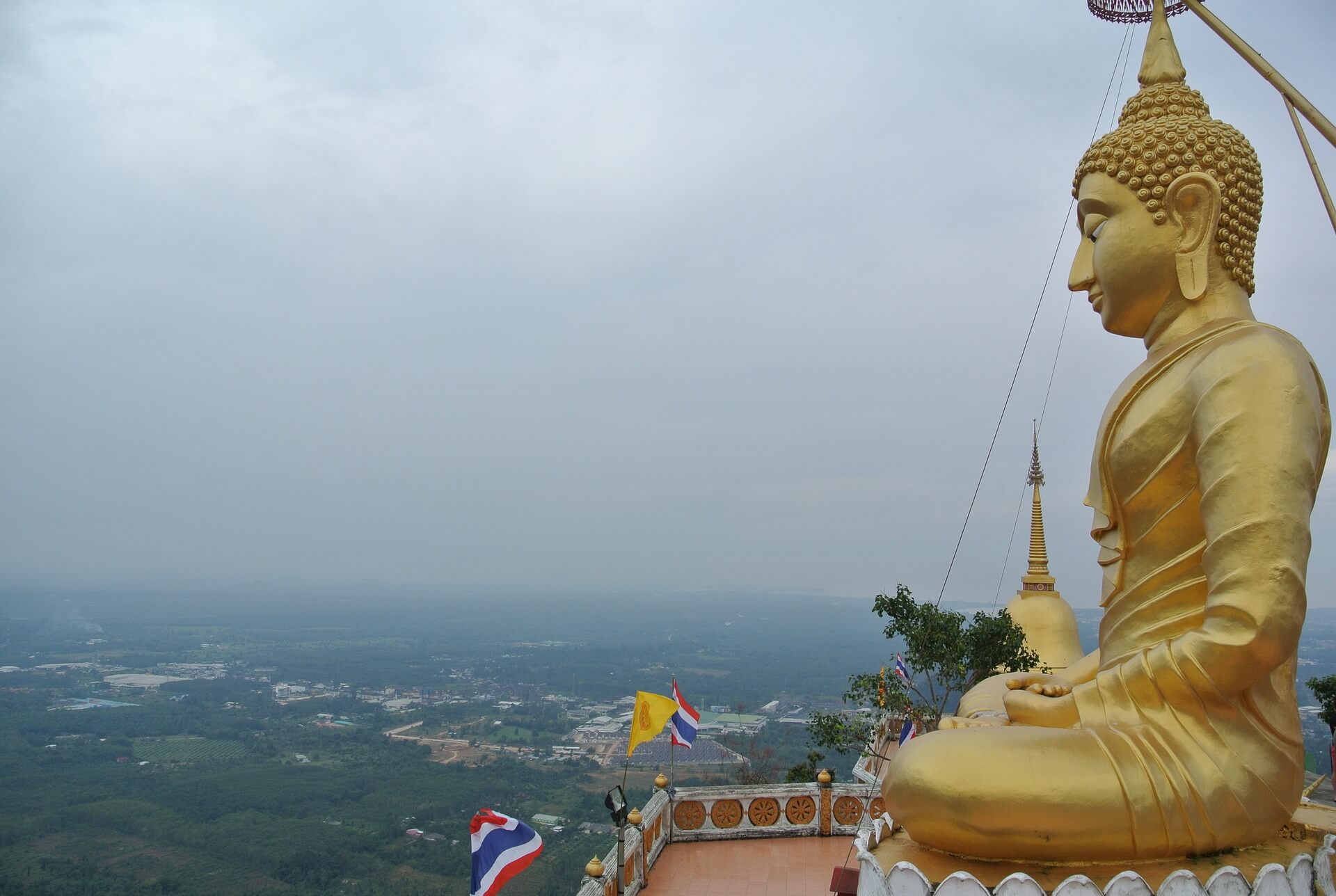 Golden Buddha statue at the summit of the Tiger Cave temple in Krabi