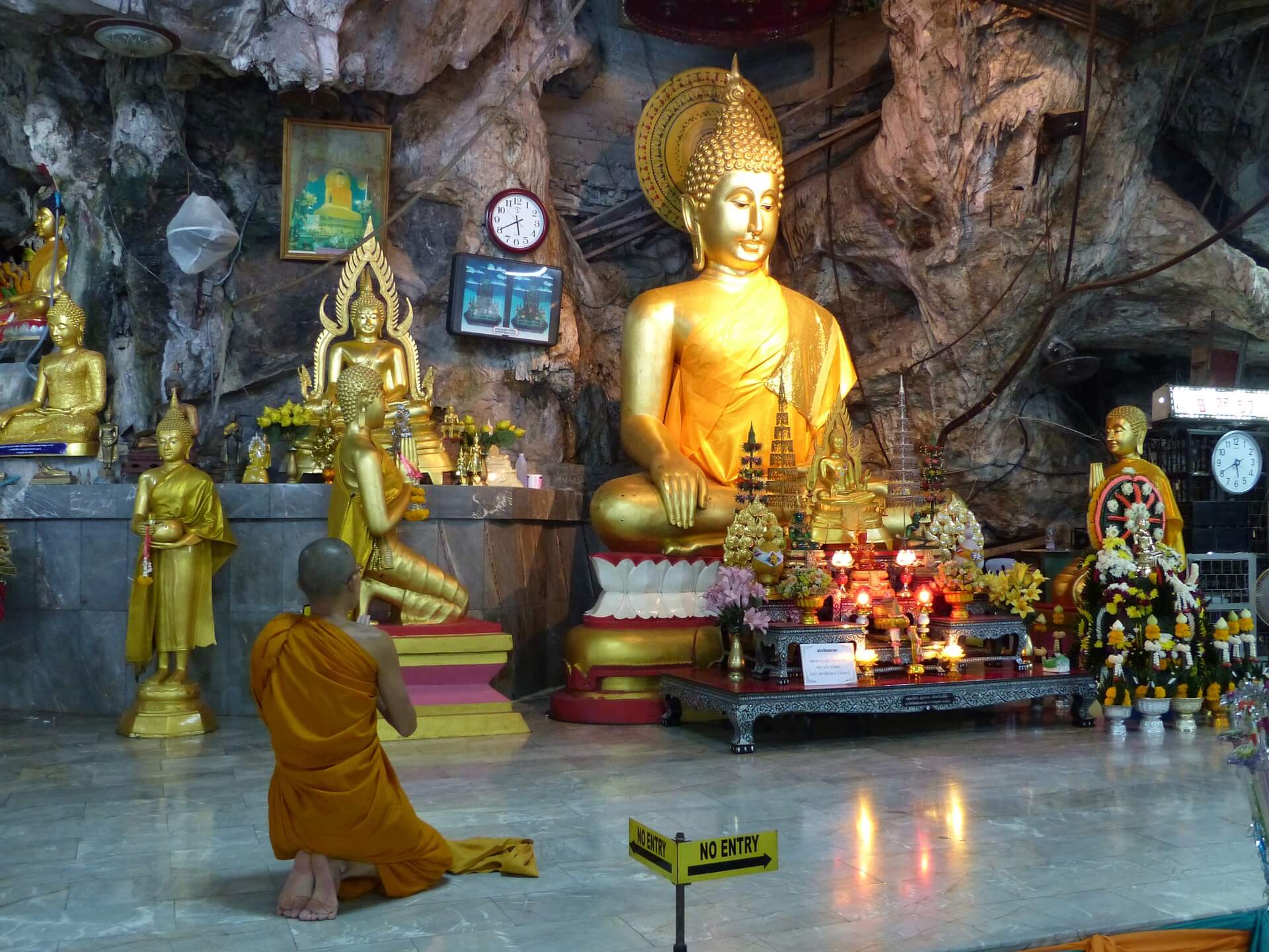 Monk praying inside the Tiger Cave temple in Krabi