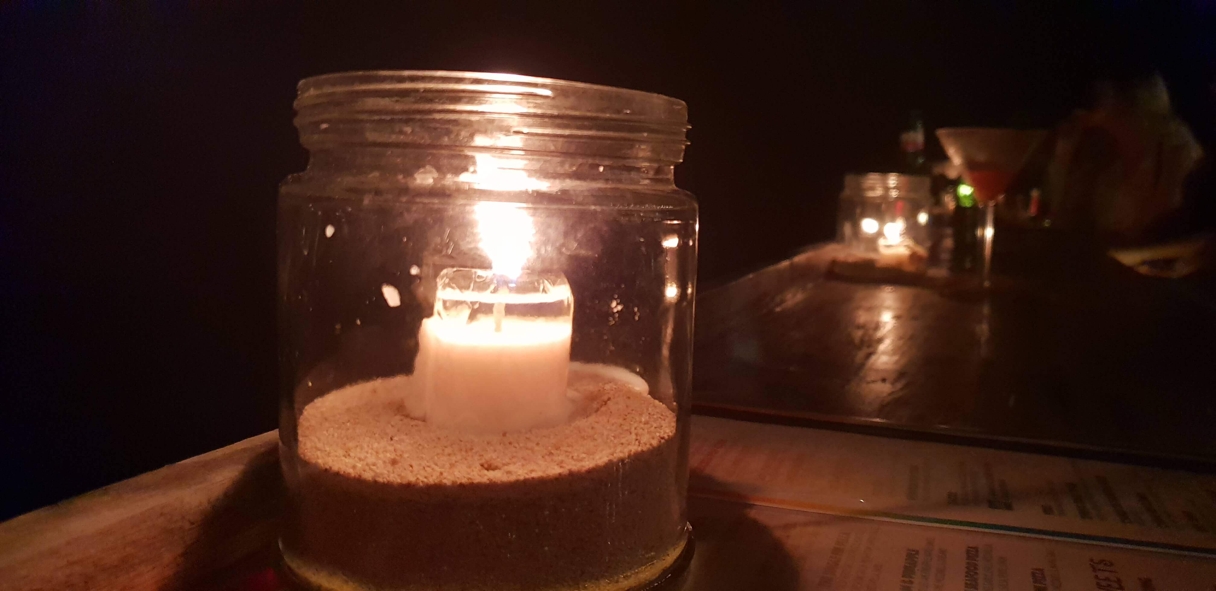 Enjoy a cozy candle-light dinner at Single Fin at night