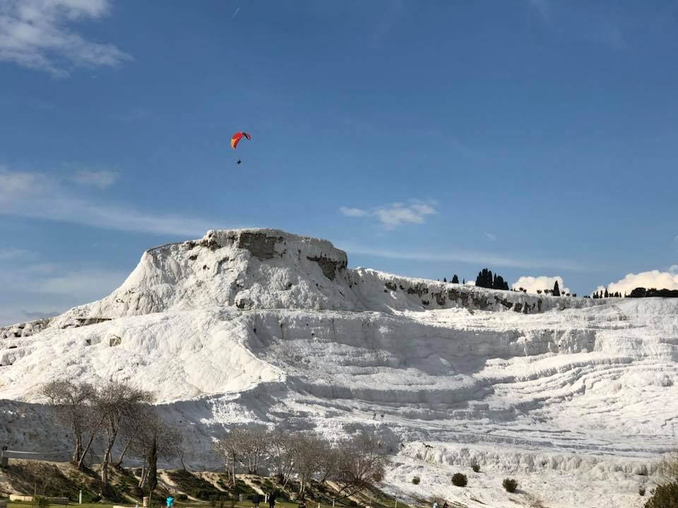 You can witness people paragliding over the breathtakingly beautiful white travertines here
