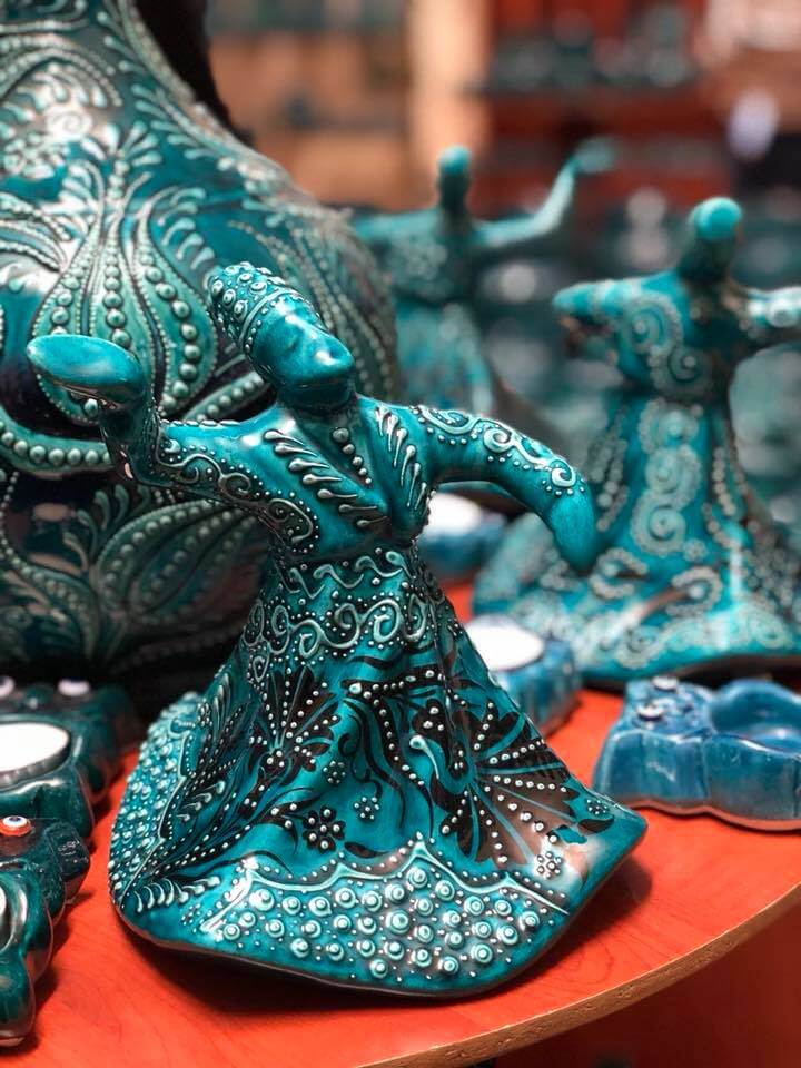Turquoise blue ceramic artwork of the "Wherling Dervishes" at the Ceramik Kapadokya pottery workshop, a place which is also one of the best shopping options in the Cappadocia Red and Green tours