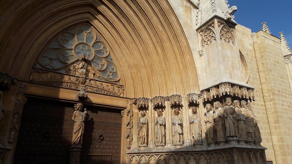 The impressive Gothic architecture with the figures of the apostles in the main portal