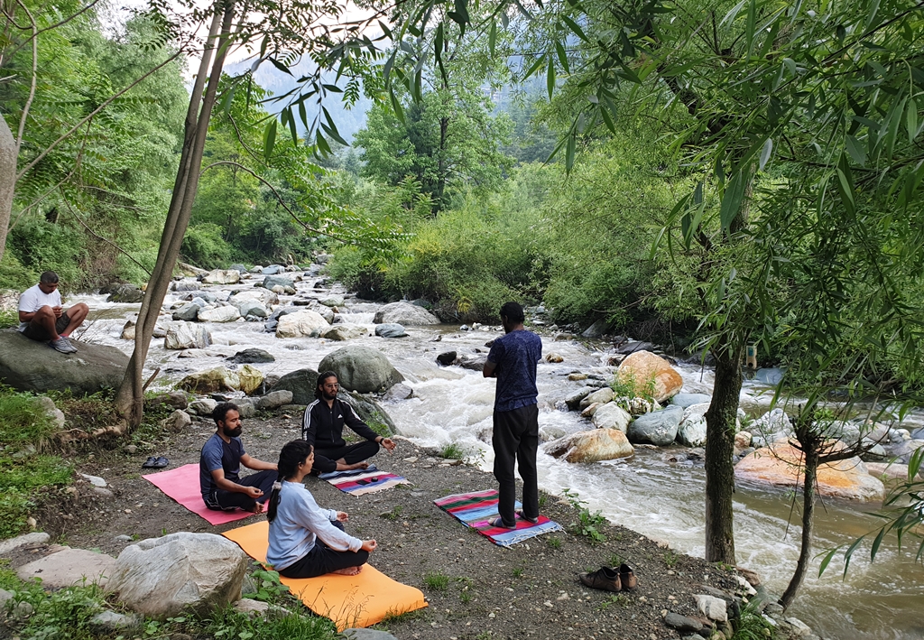 The property organizes activities like yoga sessions by the riverside
