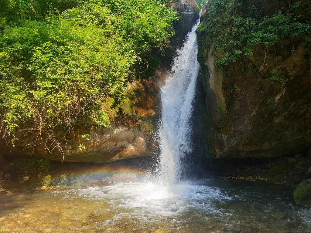 A splendid rainbow at the base of the Sajla waterfall
