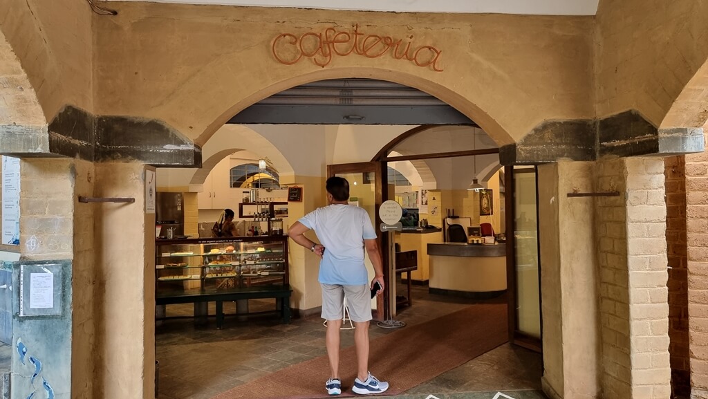 The Right Path Cafe inside Auroville Visitor's Centre can be spotted by the Cafeteria signage on the arched brick wall