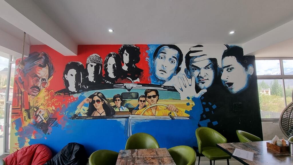 The walls of Bollywood Cafe & Sweets are decorated with paintings of iconic characters from famous Bollywood films and hence the food joint is a must-do in the 7-day Leh Ladakh itinerary for Bollywood film buffs
